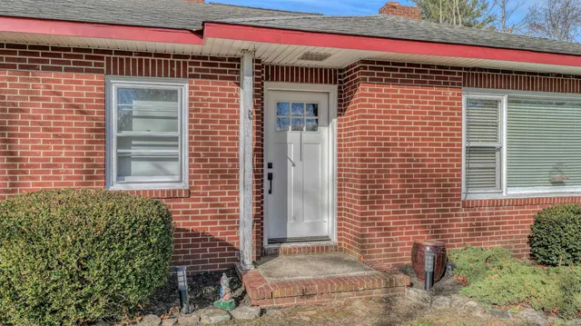 a view of a brick house with a door and wooden floor