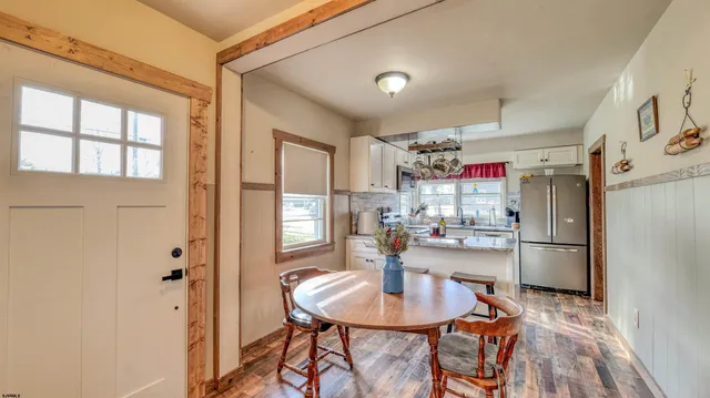 a kitchen with refrigerator and cabinets