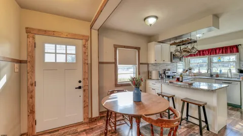 a kitchen with stainless steel appliances kitchen island granite countertop a sink and cabinets