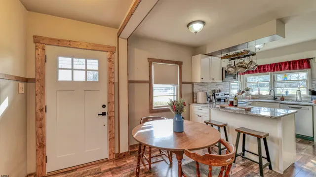 a kitchen with stainless steel appliances kitchen island granite countertop a sink and cabinets