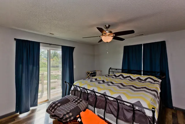 a bed sitting in a bedroom next to a window