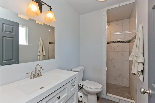 a bathroom with a sink toilet and shower