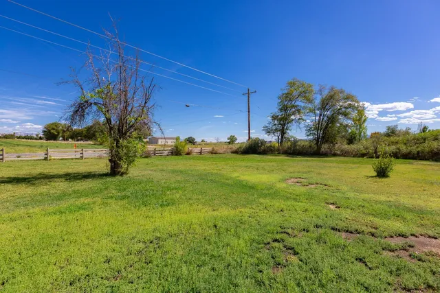 a view of a house with wooden fence