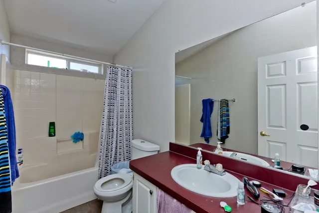 a view of empty room with window and wooden floor