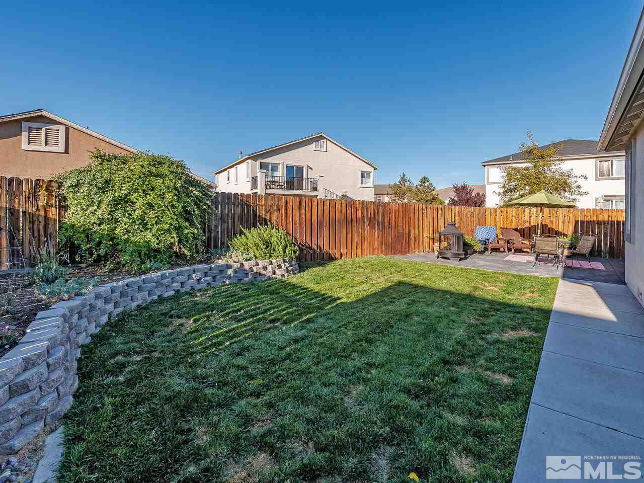 2289 Rio Lobo Lane Reno, NV 89521 - Photo 14 of 17 a backyard of a house with lots of green space and fountain