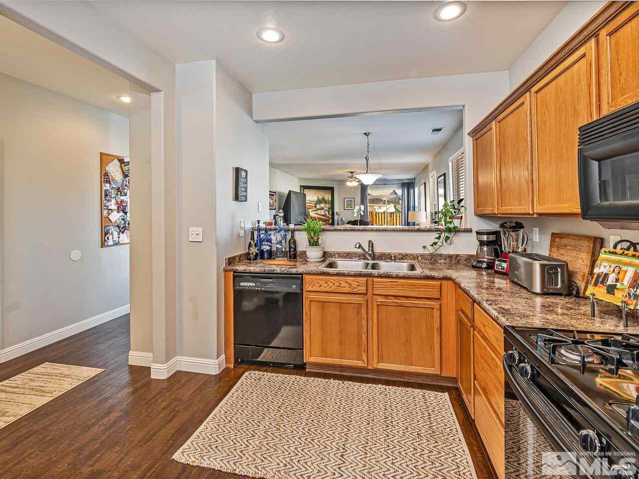 2289 Rio Lobo Lane Reno, NV 89521 - Photo 5 of 17 a kitchen with stainless steel appliances granite countertop a stove refrigerator and cabinets