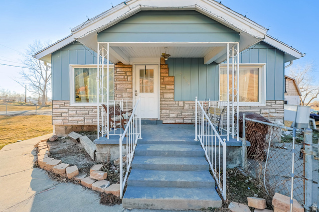 7609 Mountain View Road Lake Point, UT 84074 - Photo 2 of 16 Bungalow-style home featuring stone siding, covered porch, and board and batten siding