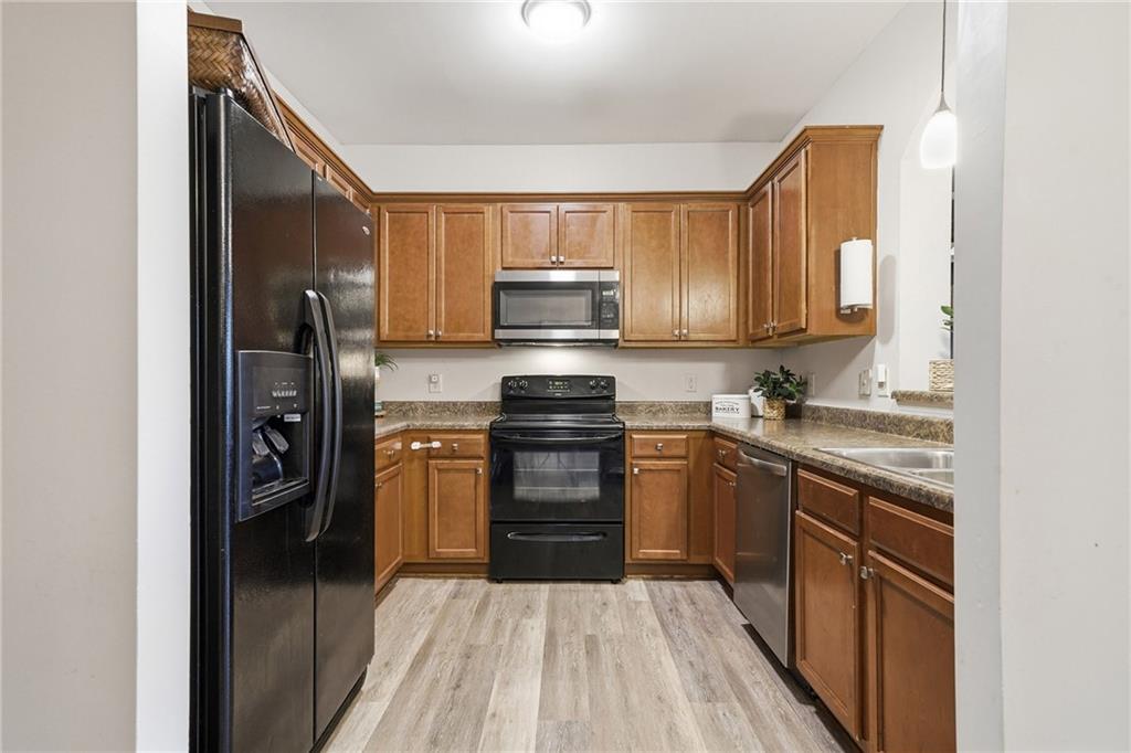 615 Myers Gate Road Ball Ground, GA 30107 - Photo 13 of 43 a kitchen with a stove sink and a refrigerator
