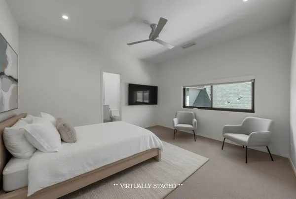 a view of an empty room with a ceiling fan