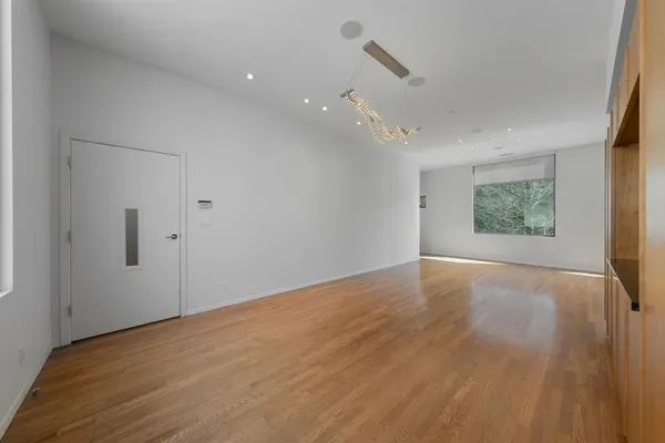a view of a room with wooden floor and window