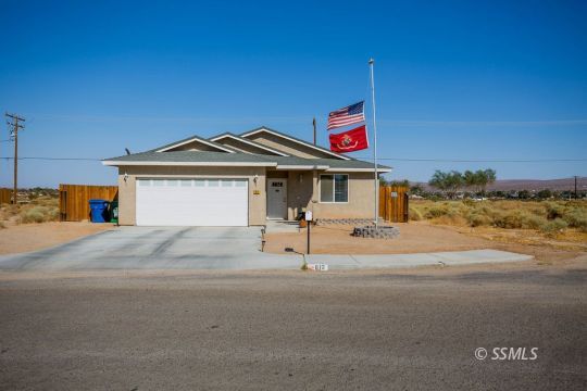 812 South Nevada Street Ridgecrest, CA 93555 - Photo 1 of 34 a house with trees in front of it