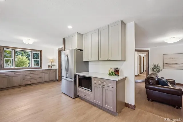 a kitchen with stainless steel appliances a refrigerator and a stove top oven