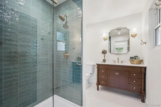 a bathroom with a shower a mirror and a sink