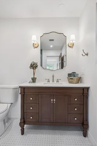 a bathroom with a double vanity sink and a mirror