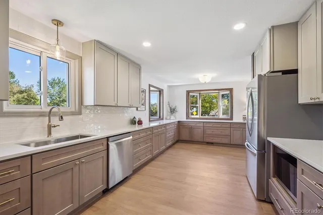 a kitchen with stainless steel appliances a refrigerator and a stove top oven
