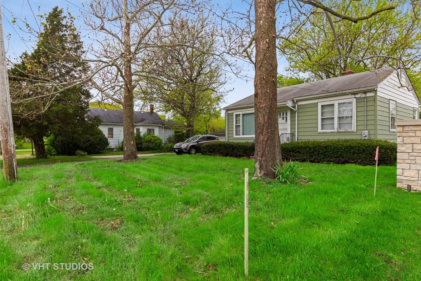 3610 York Road Oak Brook, IL 60523 - Photo 3 of 9 a view of a yard in front of a house with plants and large tree