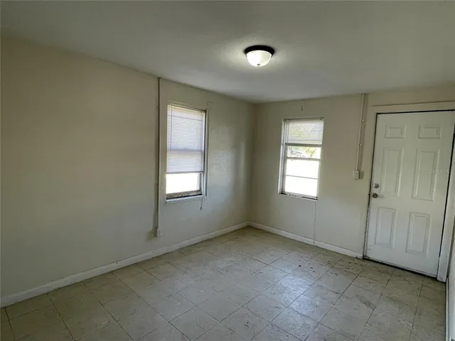 a room with a sink a stove and cabinets