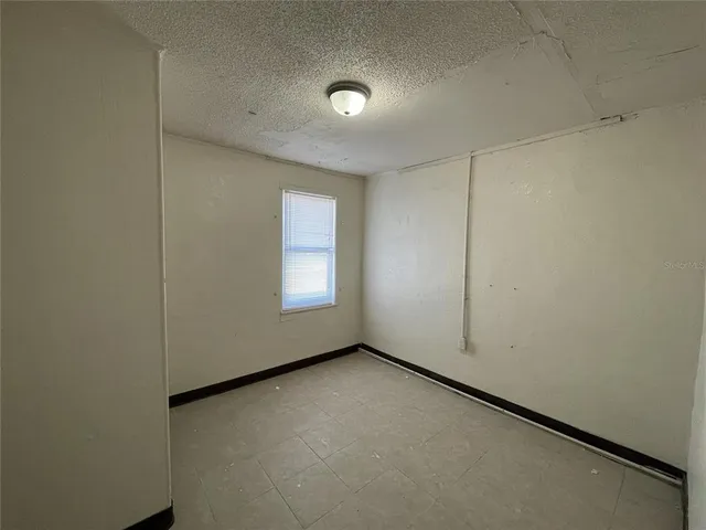 an empty room with windows and entrance