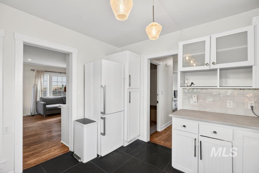 515 East D Street Moscow, ID 83843 - Photo 13 of 29 Kitchen featuring dark tile patterned floors, white cabinetry, and glass fronted cabinets