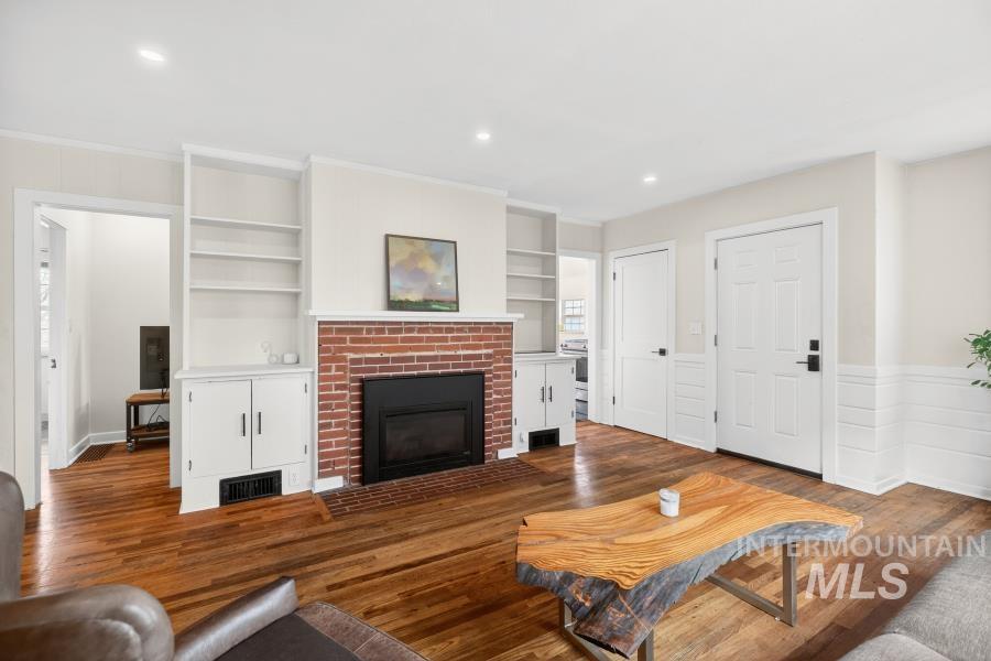 515 East D Street Moscow, ID 83843 - Photo 6 of 29 Living room featuring dark wood-style flooring, wainscoting, a fireplace, recessed lighting, and built in features