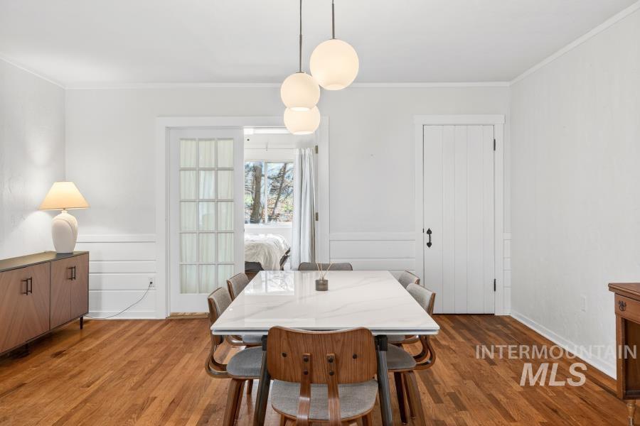 515 East D Street Moscow, ID 83843 - Photo 7 of 29 Dining room featuring ornamental molding, dark wood-style floors, a wainscoted wall, and a decorative wall