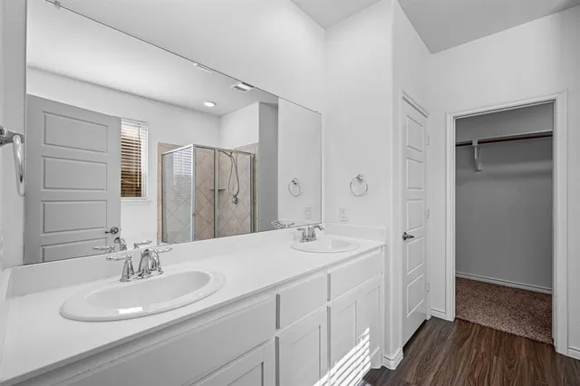 a bathroom with a double vanity sink a mirror and a