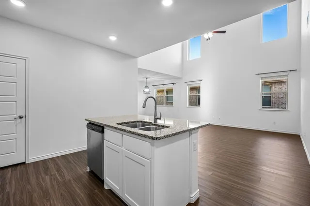 a kitchen that has a sink and a stove in it