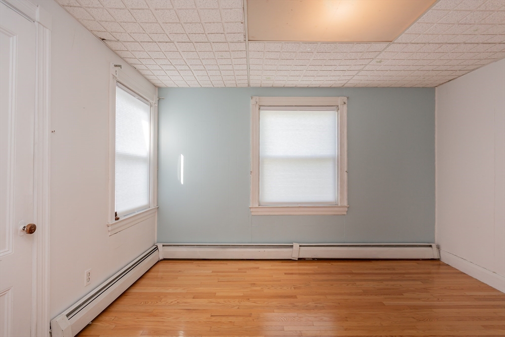 724 High Street Fall River, MA 02720 - Photo 21 of 39 a view of an empty room with wooden floor and a window