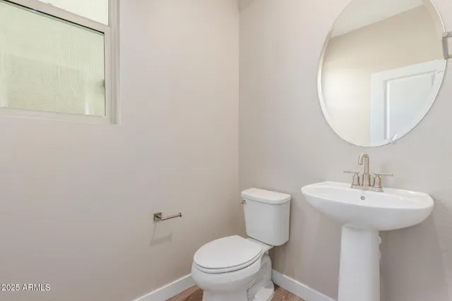 a bathroom with a sink toilet and a mirror