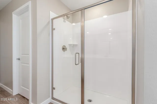 a bathroom with a glass shower door