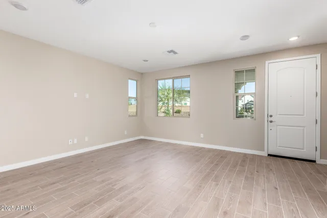 an empty room with windows and closet