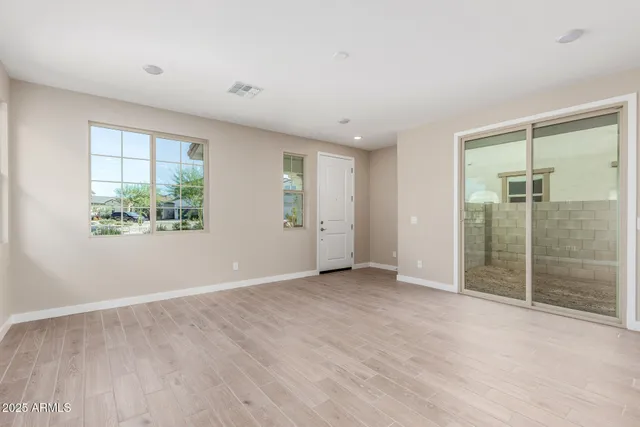 an empty room with windows and closet