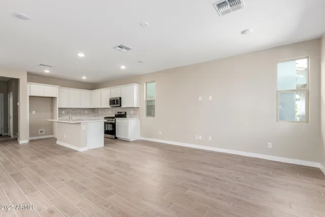 a view of kitchen with granite countertop cabinets and center island