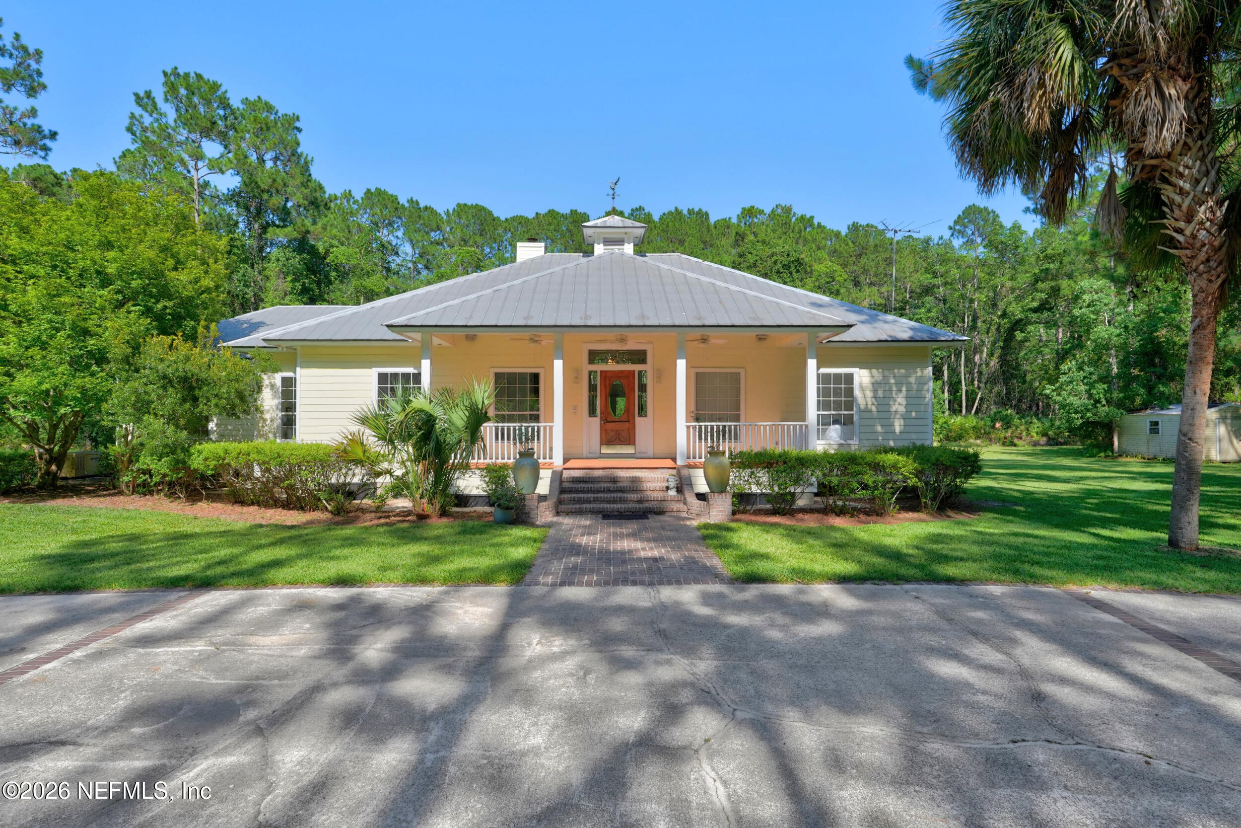 3090 Monument Bay Road St. Augustine, FL 32092 - Photo 2 of 56 a front view of a house with a yard and garage