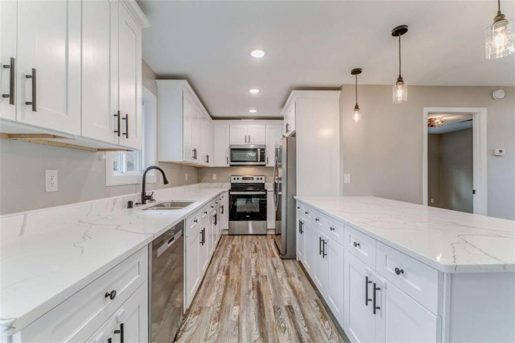 197 Colquitt Road Cedartown, GA 30125 - Photo 12 of 62 a large kitchen with stainless steel appliances granite countertop a lot of counter space and wooden floor
