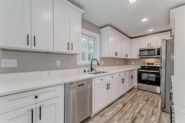 a kitchen with a sink window and cabinets