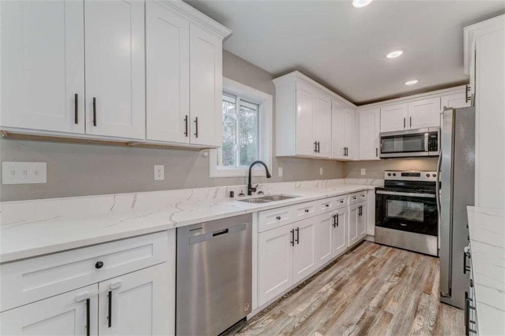197 Colquitt Road Cedartown, GA 30125 - Photo 14 of 62 a kitchen with kitchen island granite countertop a sink stainless steel appliances and cabinets