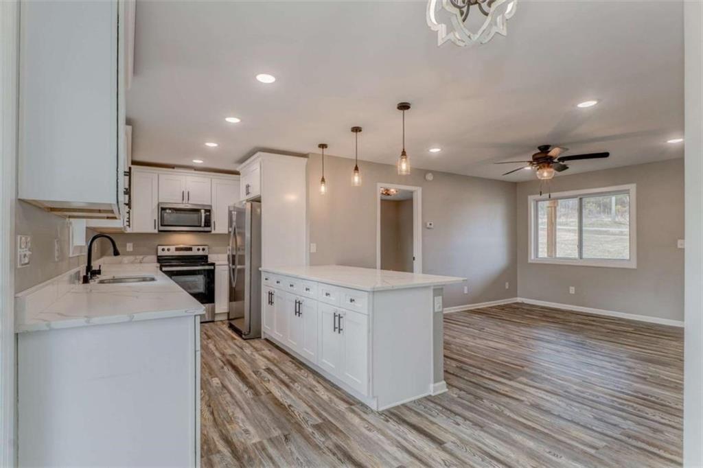 197 Colquitt Road Cedartown, GA 30125 - Photo 17 of 62 a kitchen with granite countertop a sink stainless steel appliances and cabinets