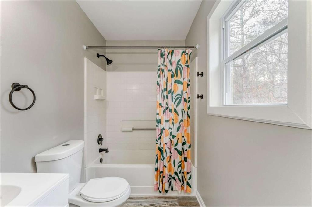 197 Colquitt Road Cedartown, GA 30125 - Photo 29 of 62 a bathroom with a toilet a sink and a shower curtain