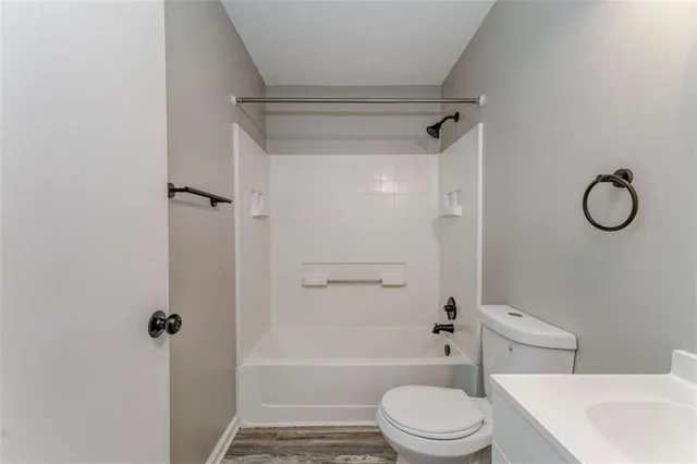 a view of a big room with windows and chandelier fan