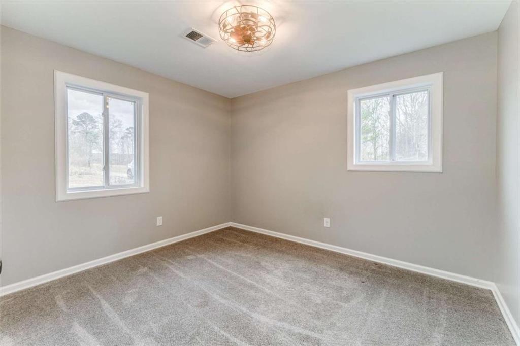 197 Colquitt Road Cedartown, GA 30125 - Photo 36 of 62 a view of a big room with windows and chandelier fan