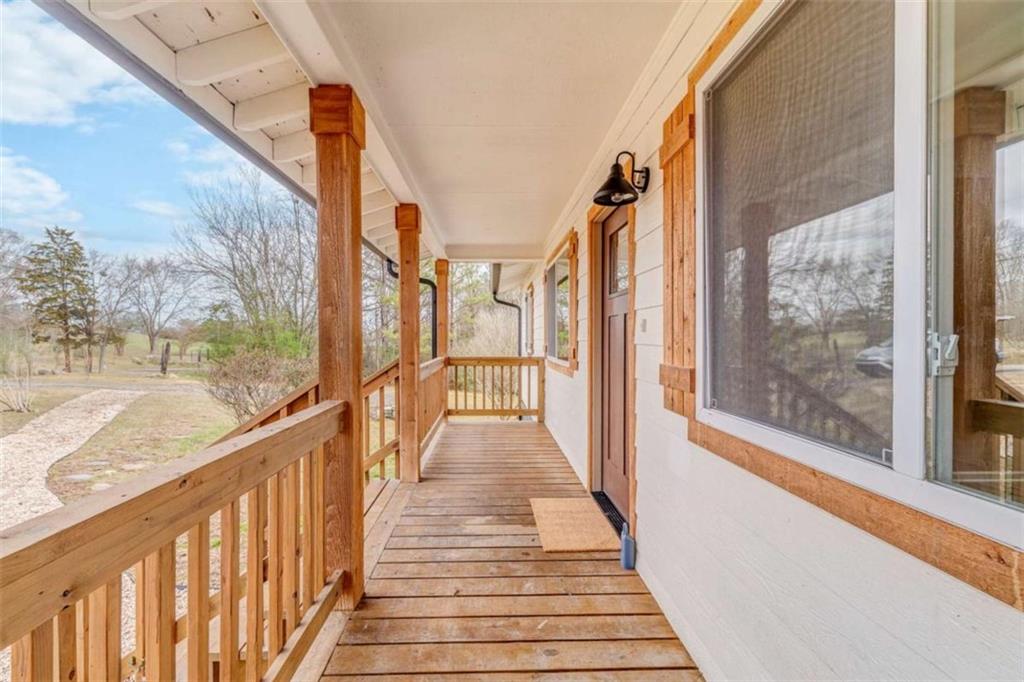 197 Colquitt Road Cedartown, GA 30125 - Photo 48 of 62 a view of a balcony with wooden floor and stairs