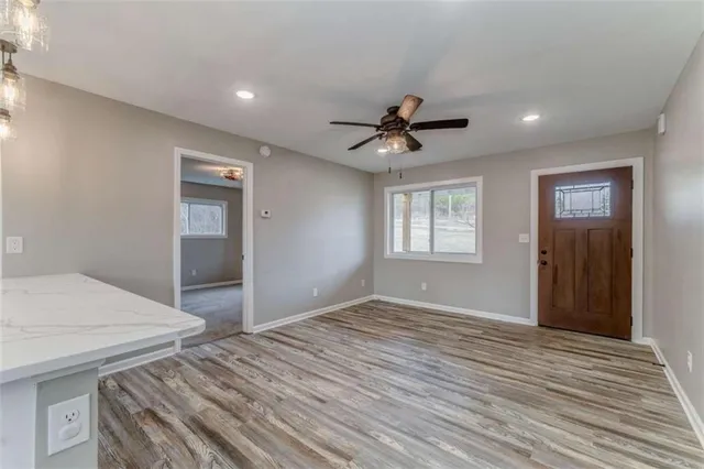 a view of kitchen with kitchen island wooden floor and ceiling fan