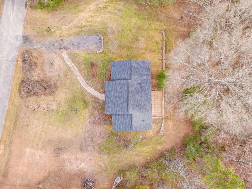 197 Colquitt Road Cedartown, GA 30125 - Photo 59 of 62 a stone house with a yard and a wooden fence