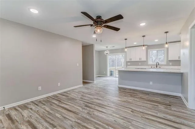 a large kitchen with kitchen island a sink stainless steel appliances and cabinets