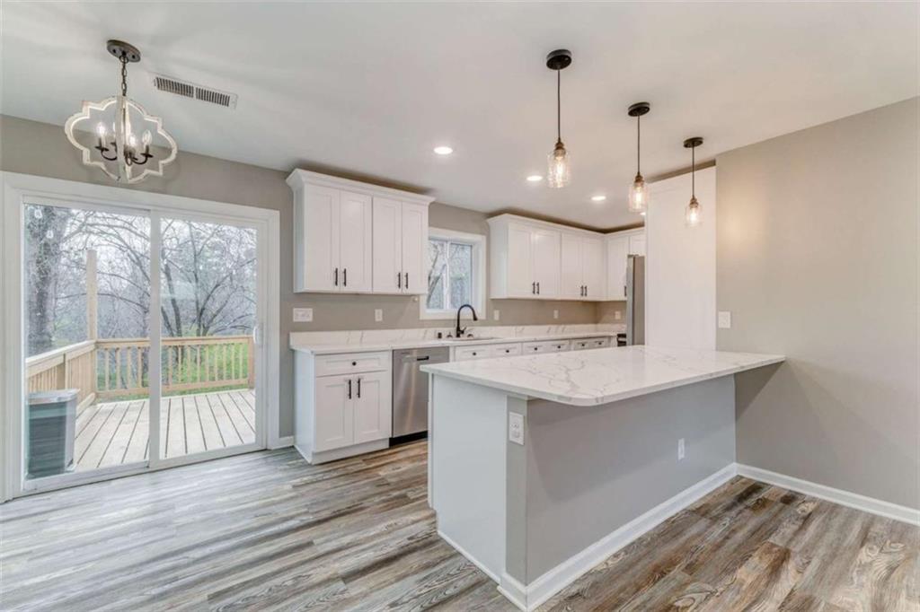 197 Colquitt Road Cedartown, GA 30125 - Photo 10 of 62 a kitchen with a stove a sink and wooden floor