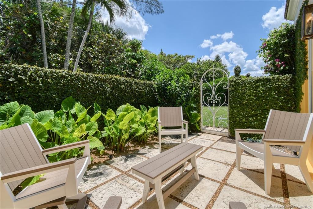 485 South Beach Road Hobe Sound, FL 33455 - Photo 11 of 12 a view of a chairs and table in a backyard