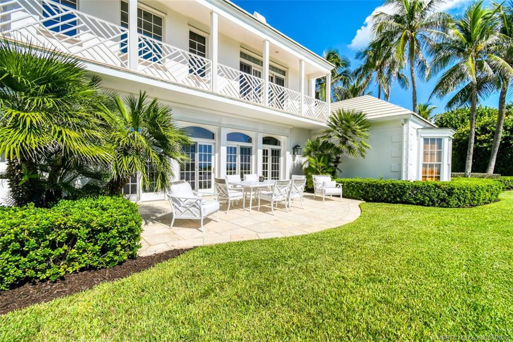 485 South Beach Road Hobe Sound, FL 33455 - Photo 8 of 12 a view of a house with patio and a garden