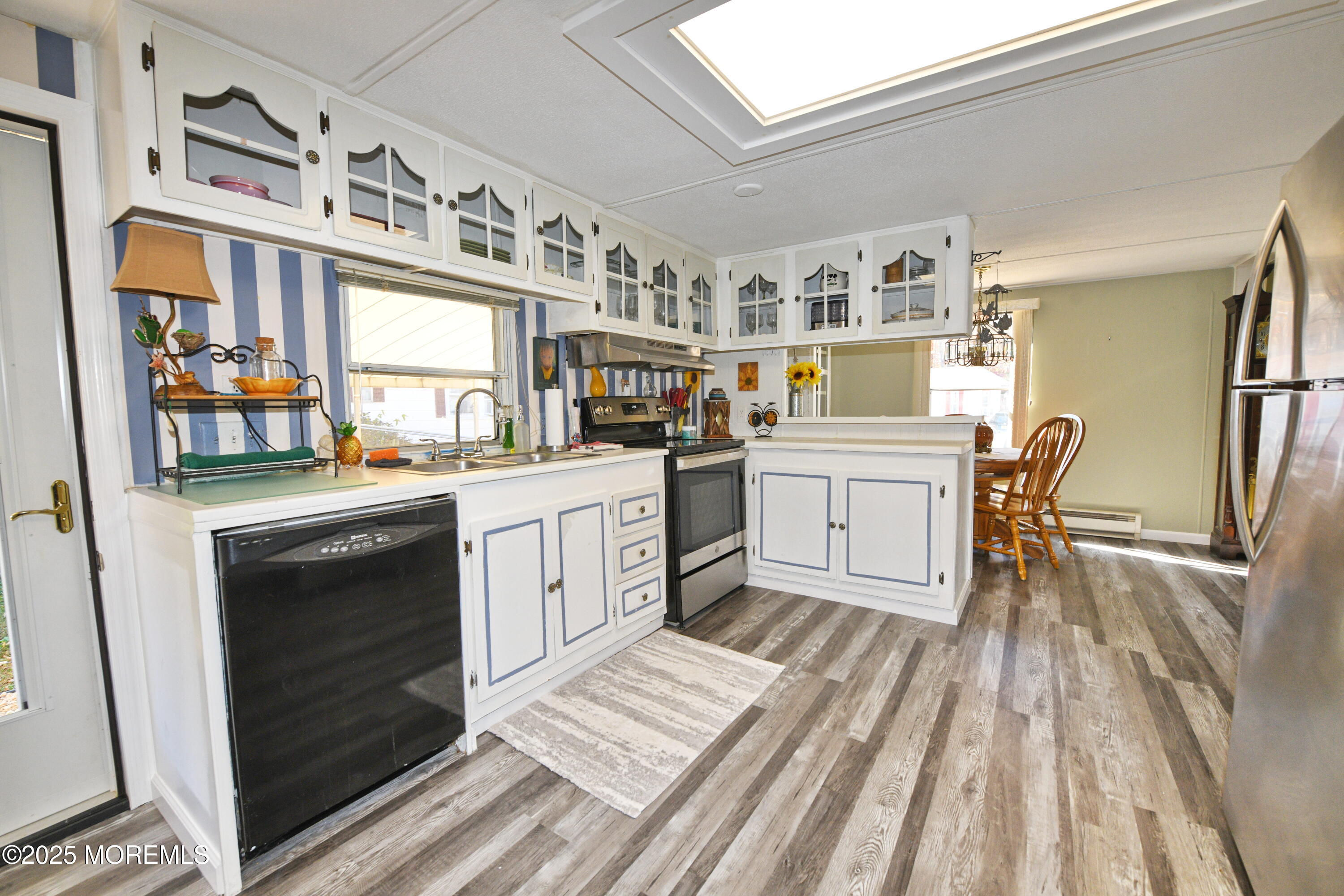 35 Judith Way Jackson, NJ 08527 - Photo 6 of 20 a kitchen with stainless steel appliances a stove a sink dishwasher and cabinets with wooden floor
