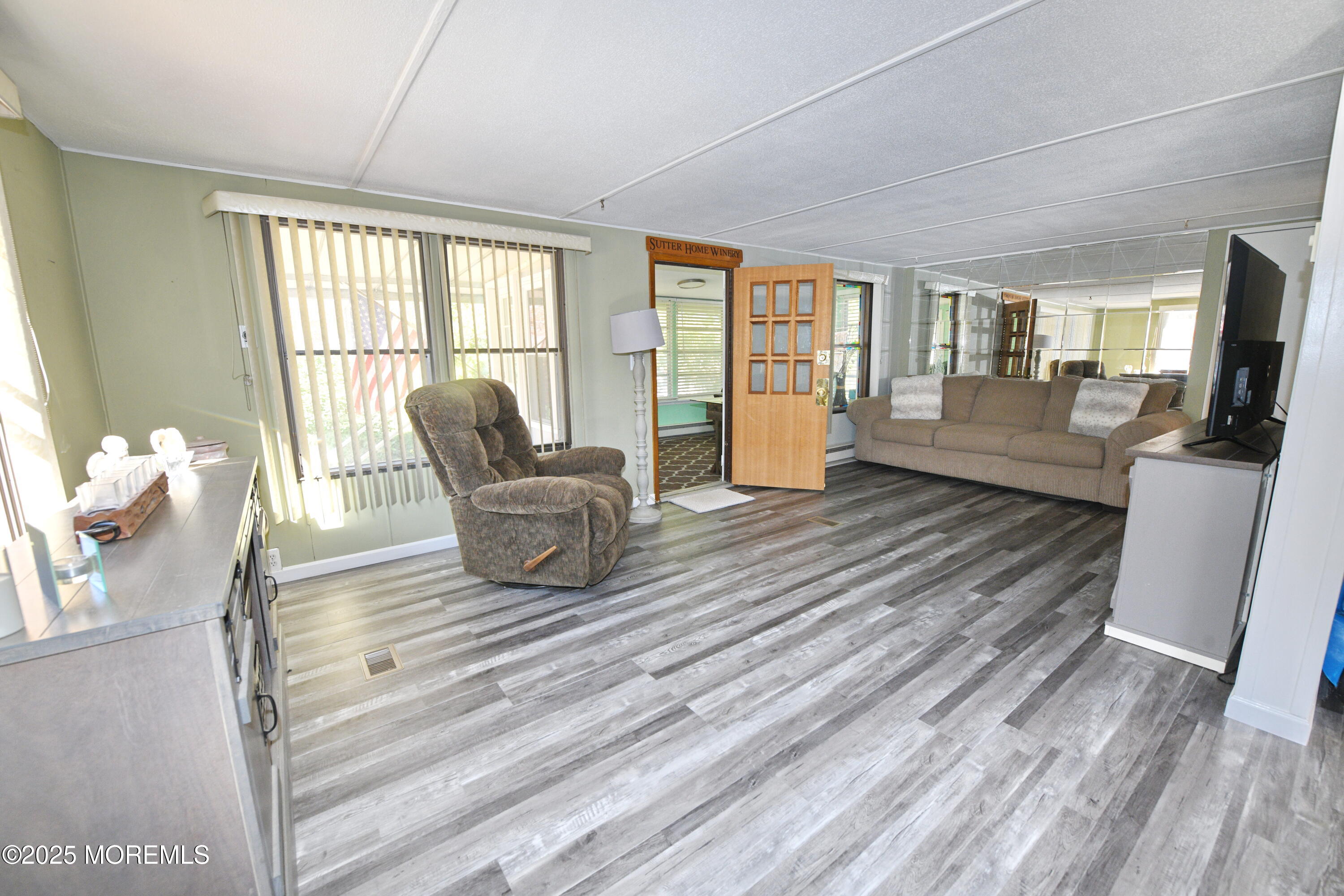35 Judith Way Jackson, NJ 08527 - Photo 9 of 20 a living room with furniture large window and wooden floor